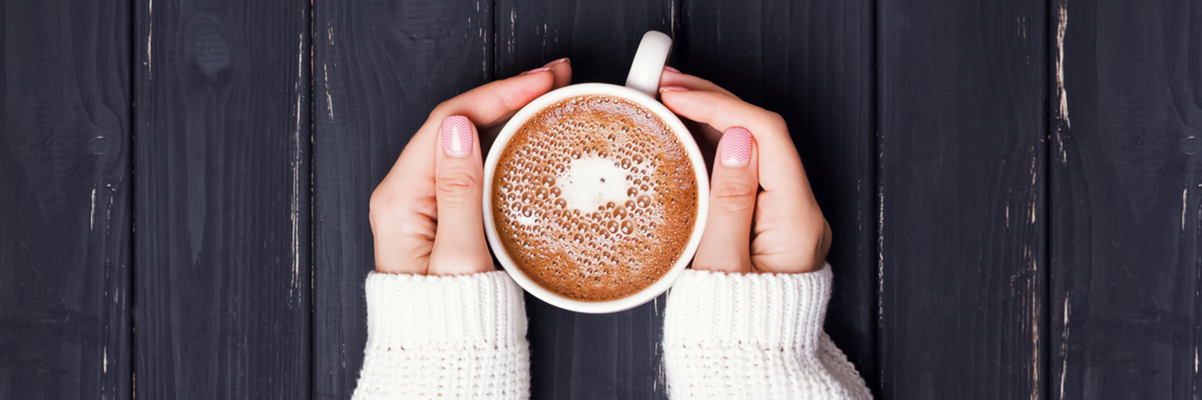 Hands holding a cup of coffee - Dairy and Ice cream - AAK