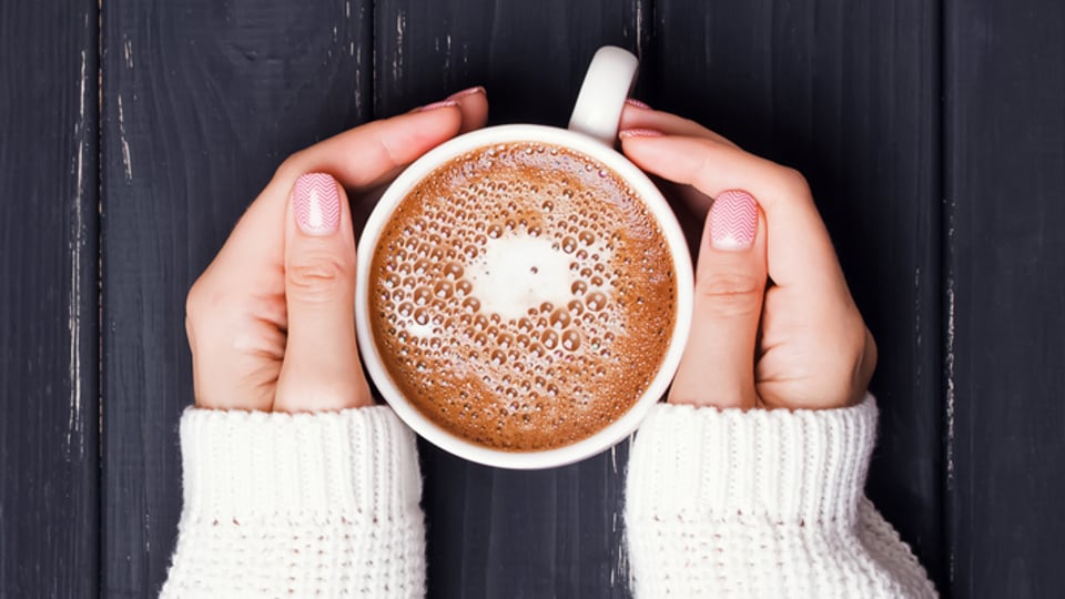Hands holding a cup of coffee - Dairy and Ice cream - AAK
