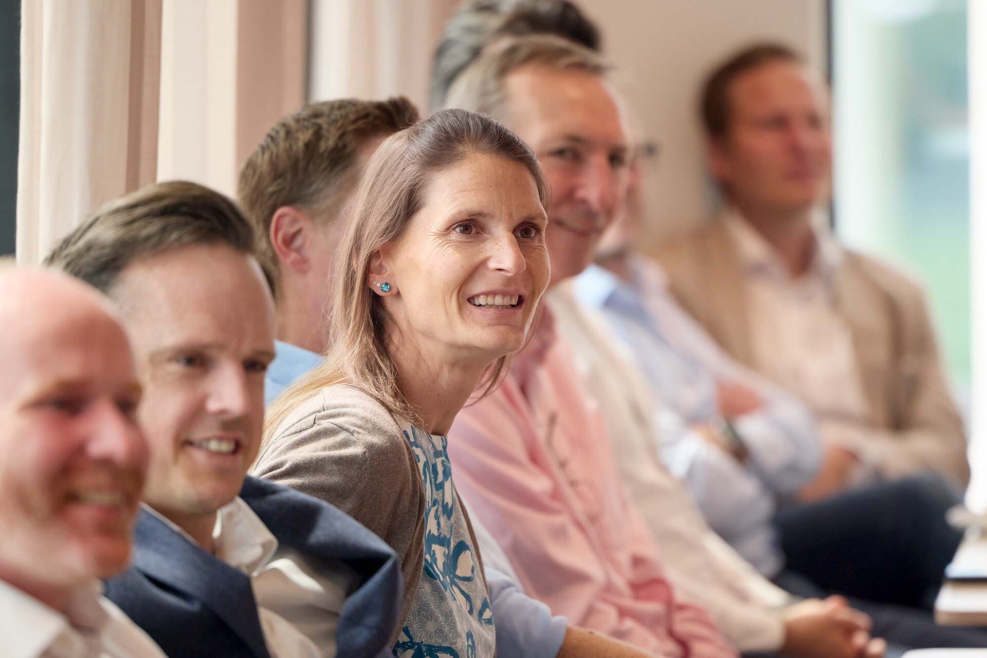AAK employees seated in a row during a meeting or presentation, listening attentively