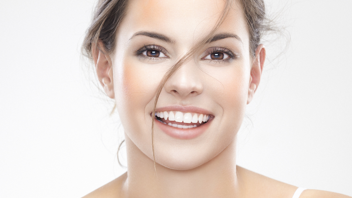 Ansiktet hos en brunögd kvinna som skrattar - Foder - AAK