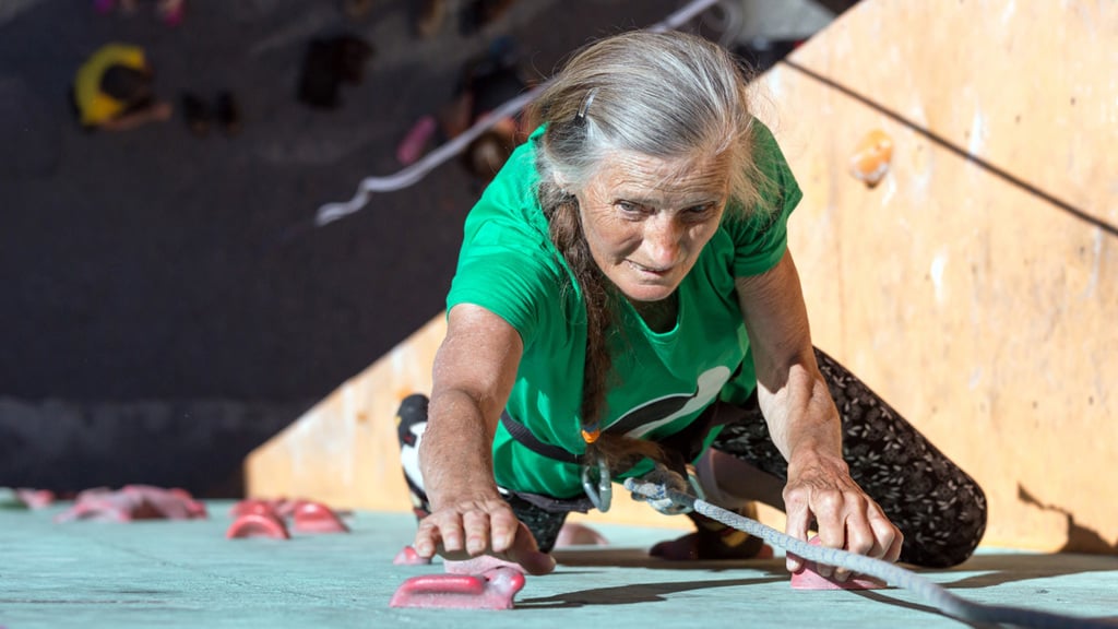 Older woman climbing up a wall - Special Nutrition - AAK