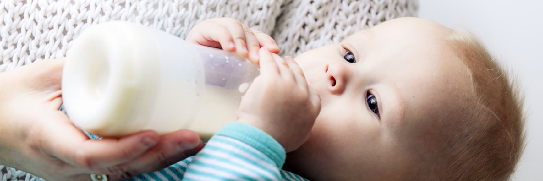 Baby drinking from a feeding bottle - Special Nutrition - AAK