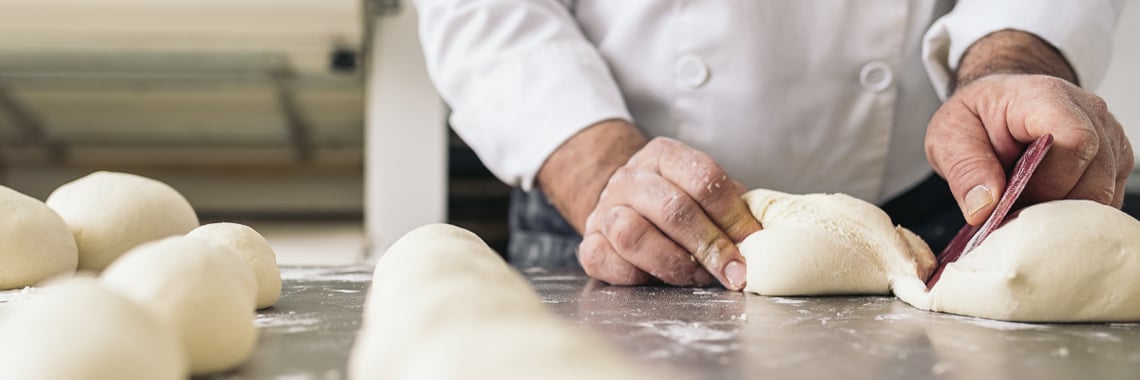 Baker Dividing Bread Dough Into Pieces - Bakery - AAK