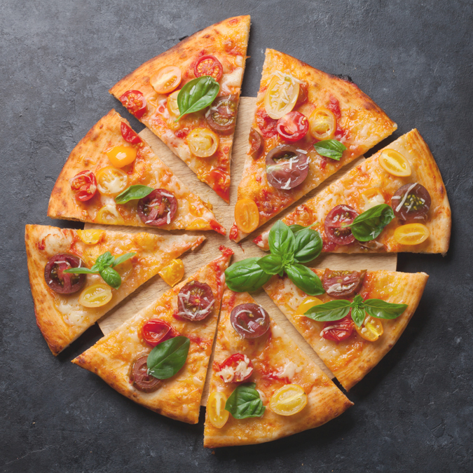 Delicious Pizza with Basil and Tomato on a Marble Table - Bakery - AAK