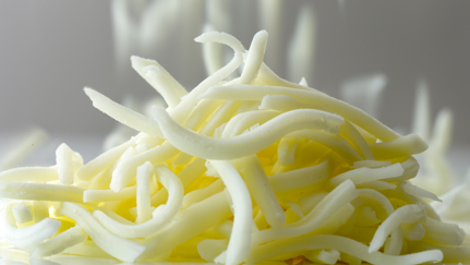 Close-up of a pile of grated cheese - Co-Development - AAK