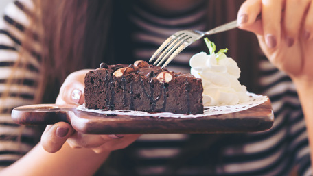 Chocolate cake and whipped cream on a plate - Applications - AAK