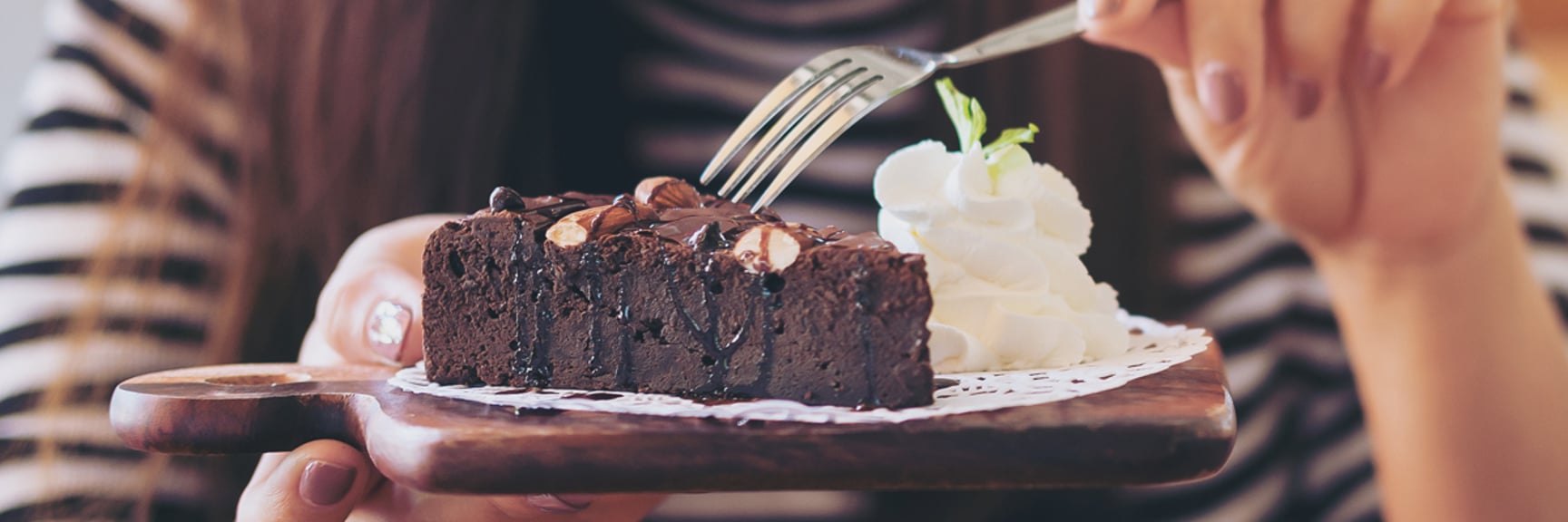 Chocolate cake and whipped cream on a plate - Applications - AAK