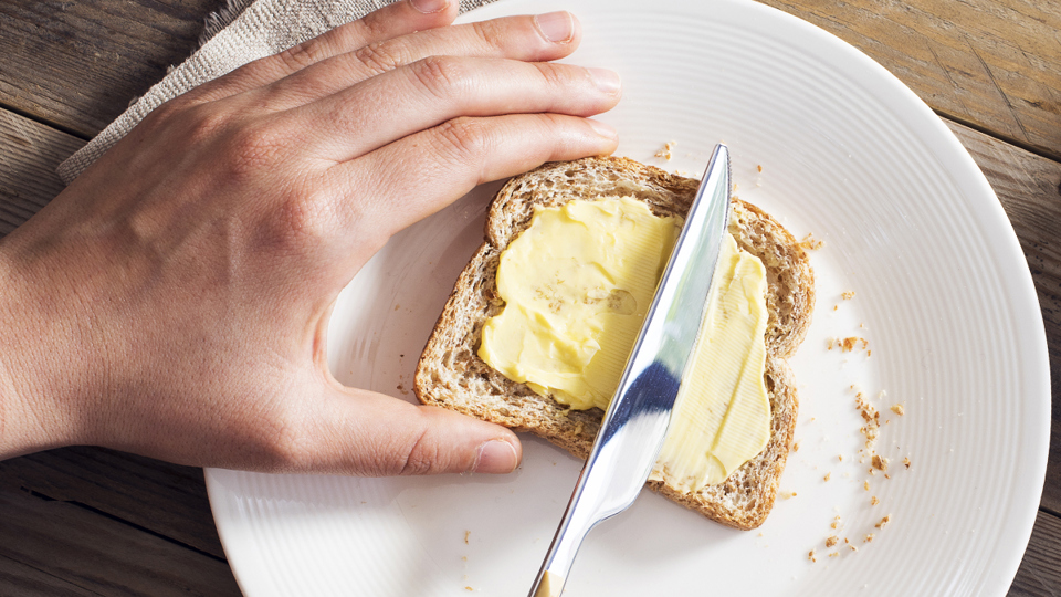 Buttering a slice of bread - Dairy and Ice cream - AAK