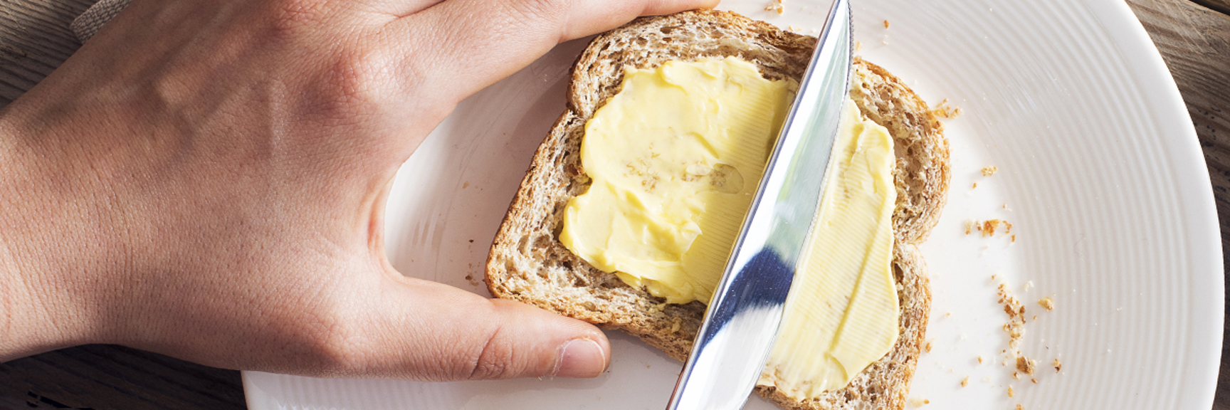 Buttering a slice of bread - Dairy and Ice cream - AAK
