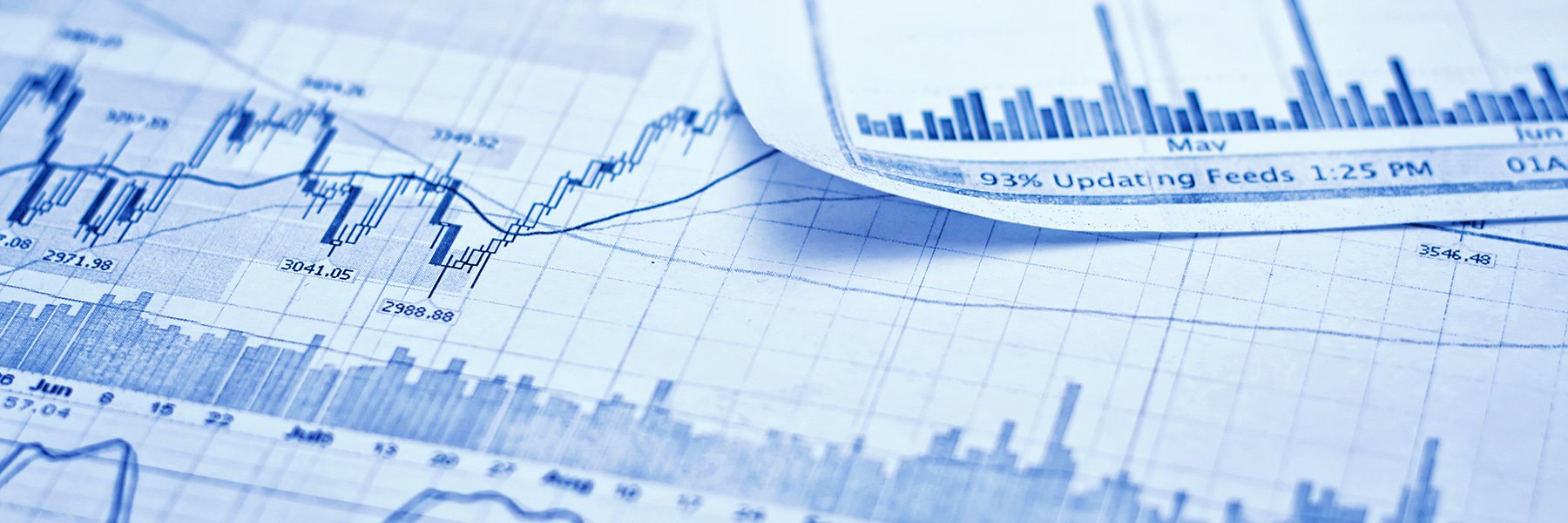 Close-up of financial charts and bar graphs showing stock prices and market data.