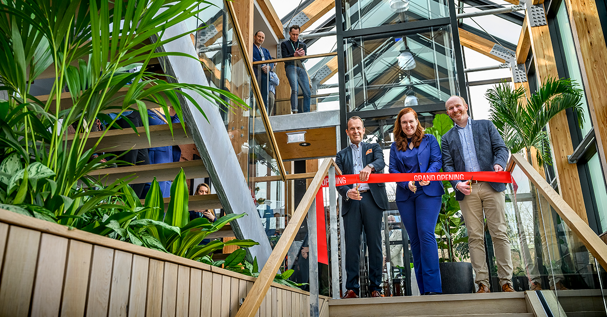 The grand opening of Innovation center where a red ribbon gets cut inside of the building.