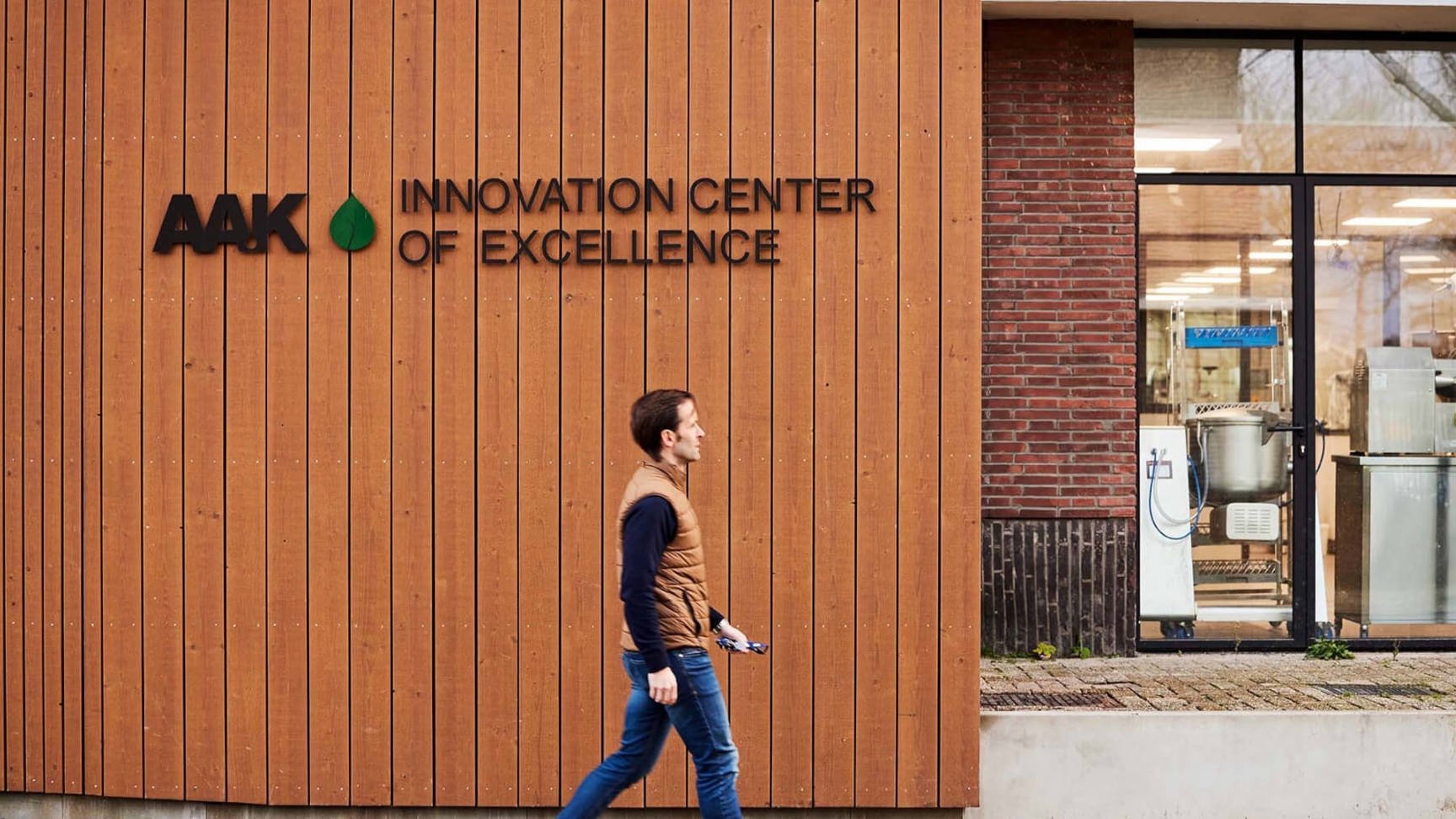 Man walking in front of the AAK innovation center of excellence building.