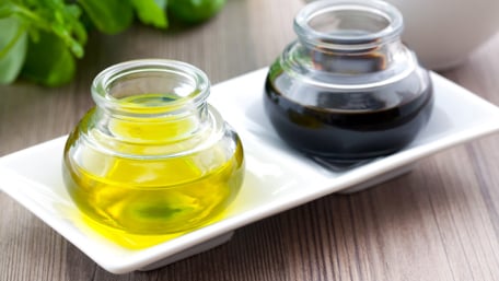 Two bottles of vegetable oil on a plate - Foodservice and Retail - AAK