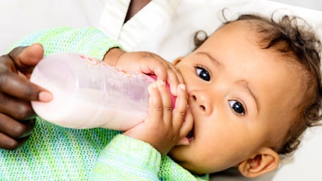Baby drinking from a feeding bottle - Special Nutrition - AAK