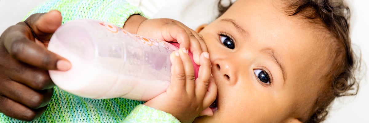 Baby drinking from a feeding bottle - Special Nutrition - AAK