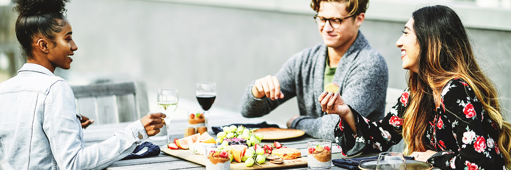 Three people having lunch and laughing.