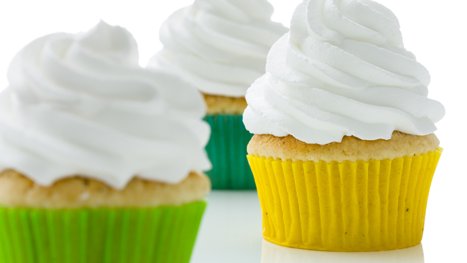 Muffin in colorful forms and topped with whipped cream - Co-Development - AAK