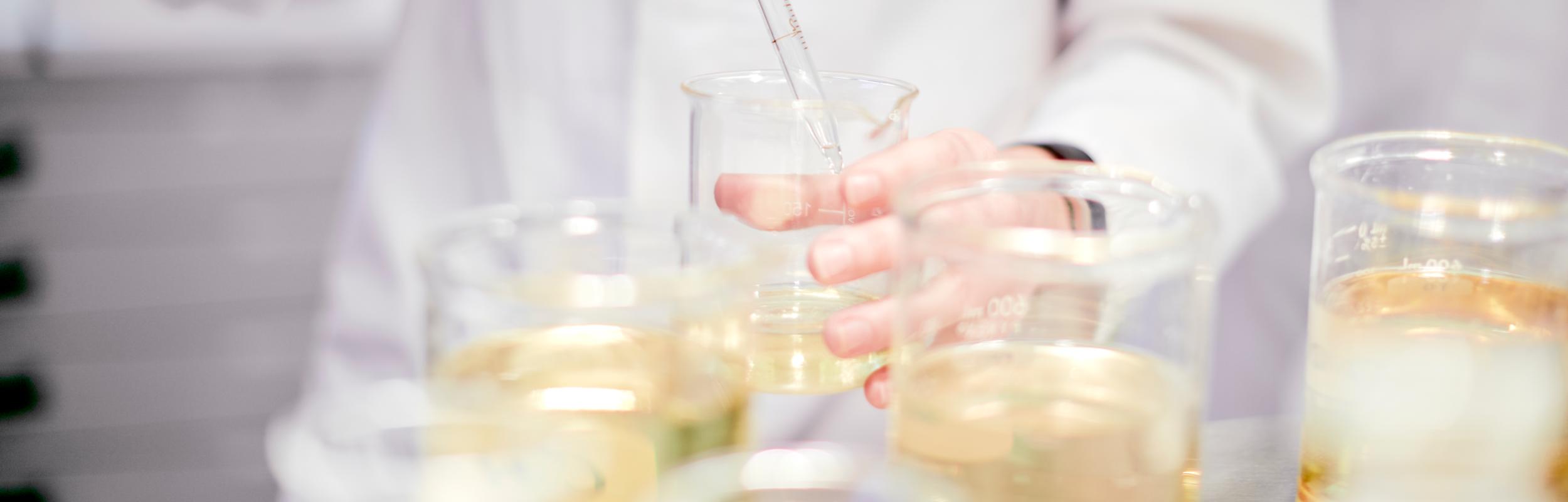 Oil is handled with a pipette in the laboratory.