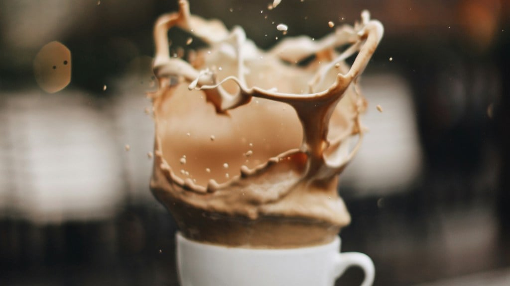 Coffee splashing out of a white cup, captured mid-air.